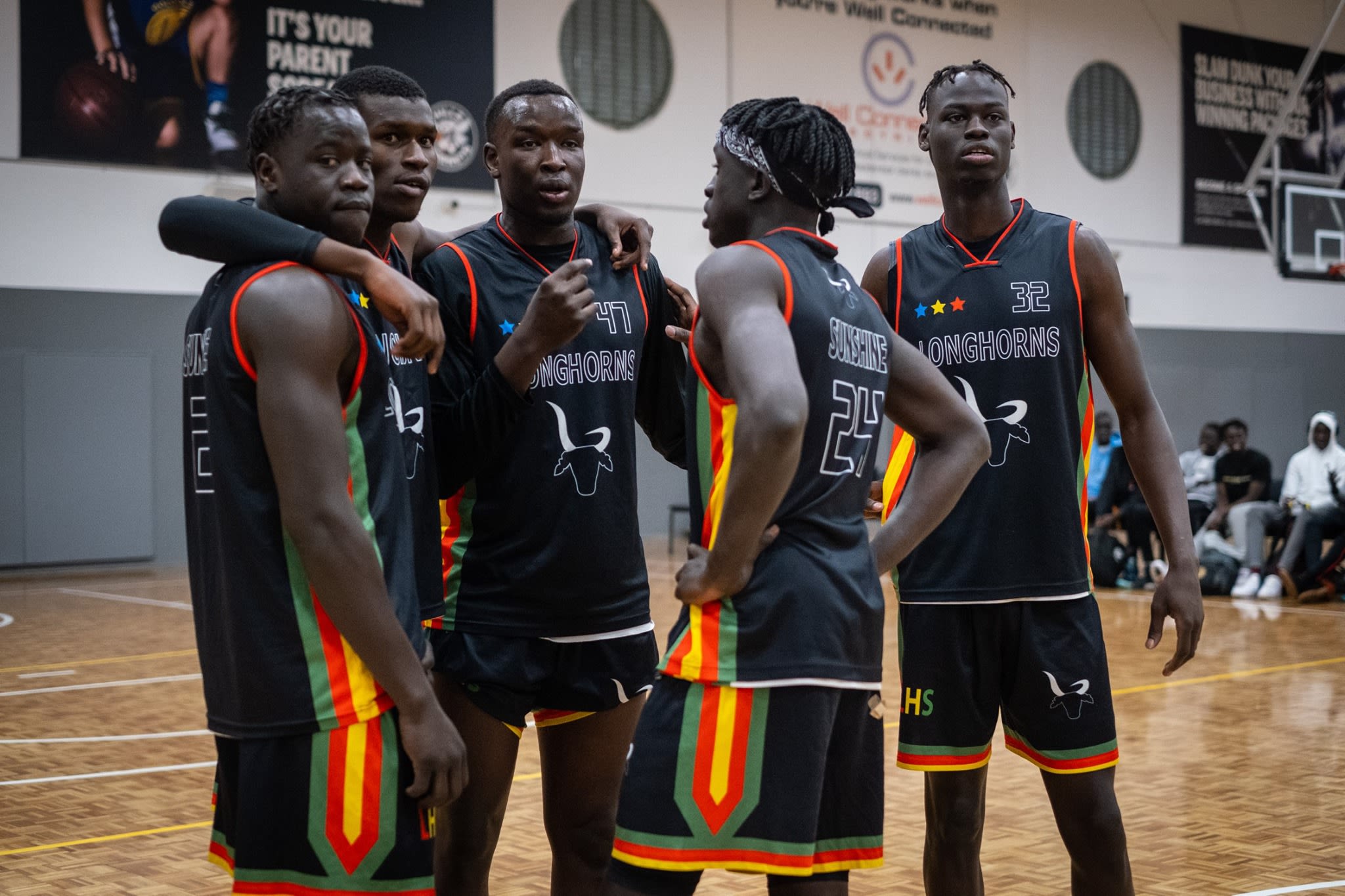 South Sudanese Basketballers in a huddle 